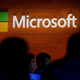 The Microsoft logo is illuminated on a wall during a Microsoft launch event to introduce the new Microsoft Surface laptop and Windows 10 S operating system, May 2, 2017 in New York City.